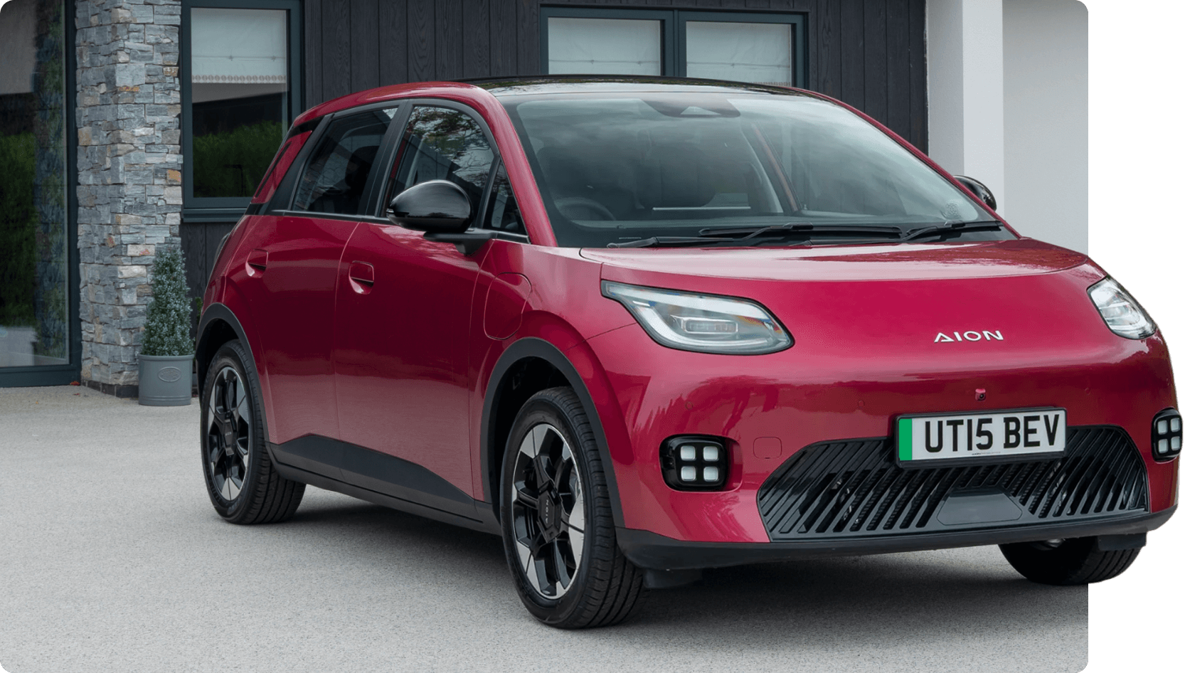 Red AION UT parked outside a modern home