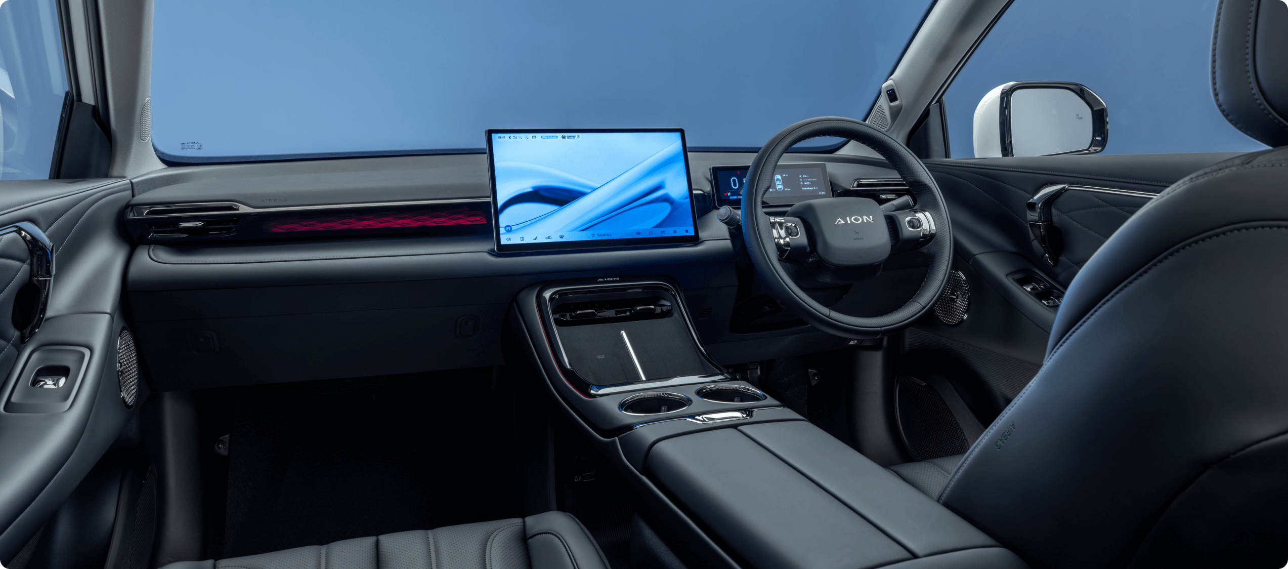 Interior of the AION V showing digital display, steering wheel and centre console