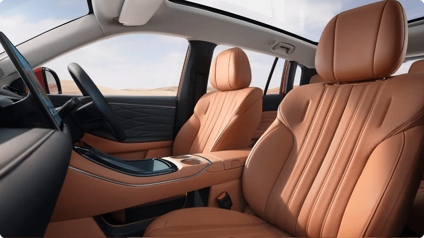 Front interior of the AION V showing tan leather seats, centre console and panoramic roof