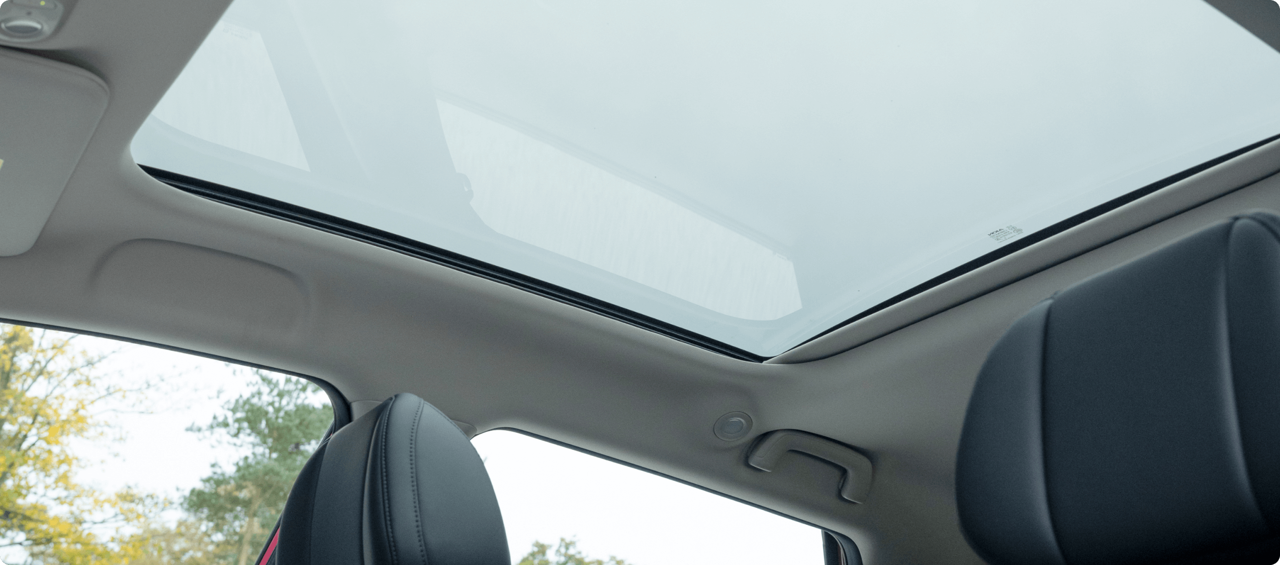 Interior view of the AION UT showing the panoramic glass roof