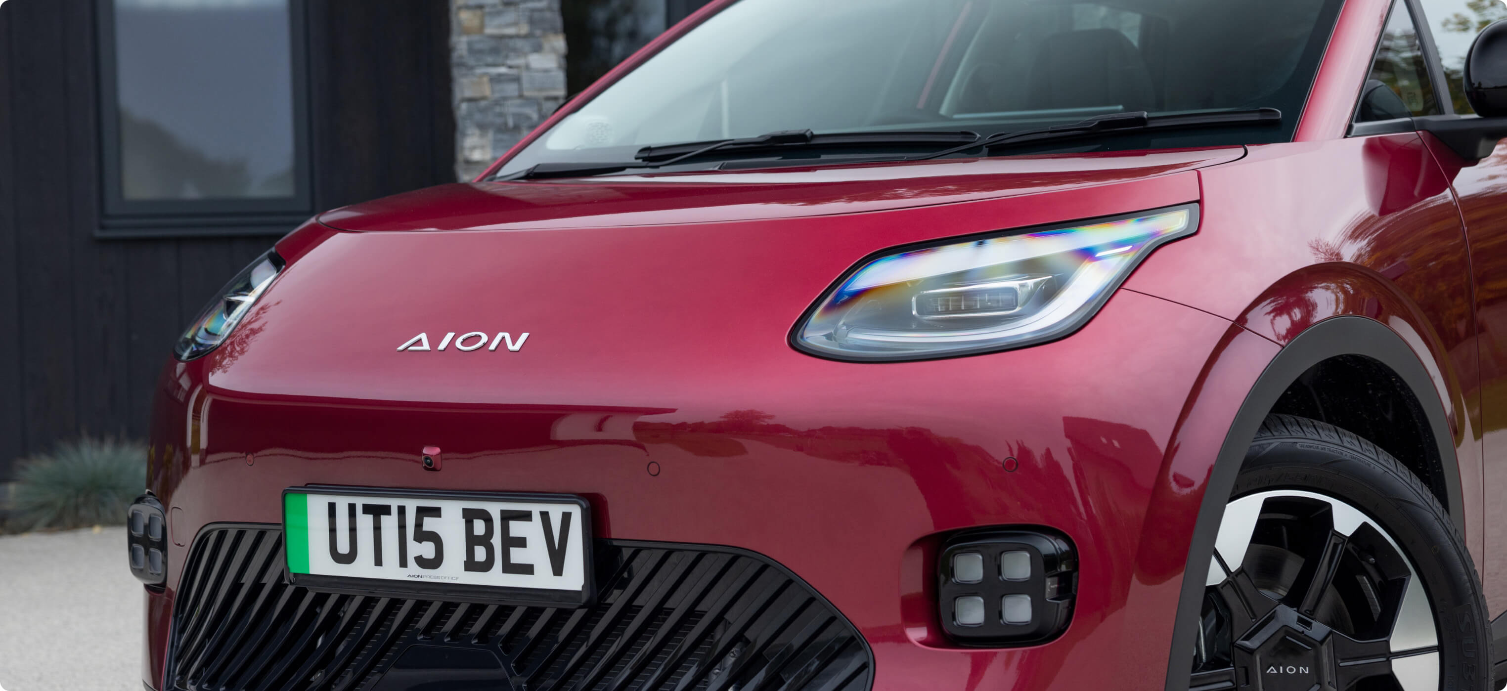 Front view of the AION UT showing the headlights, grille and AION badge