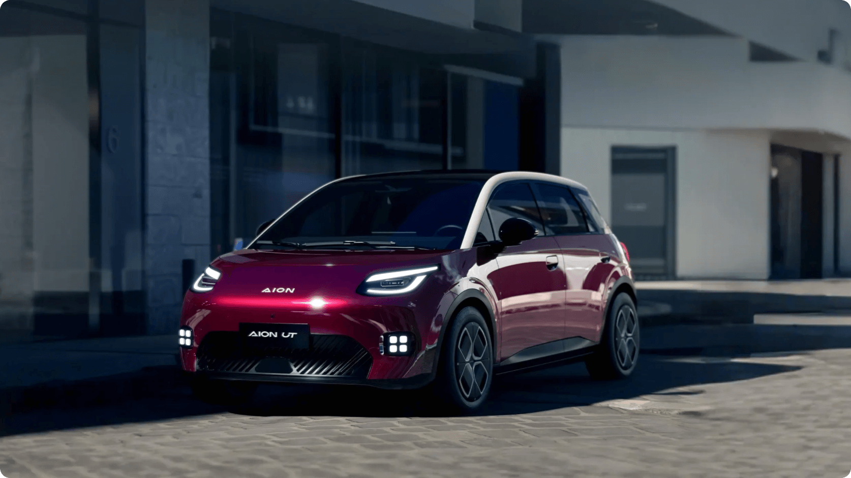 AION UT driving through an urban environment