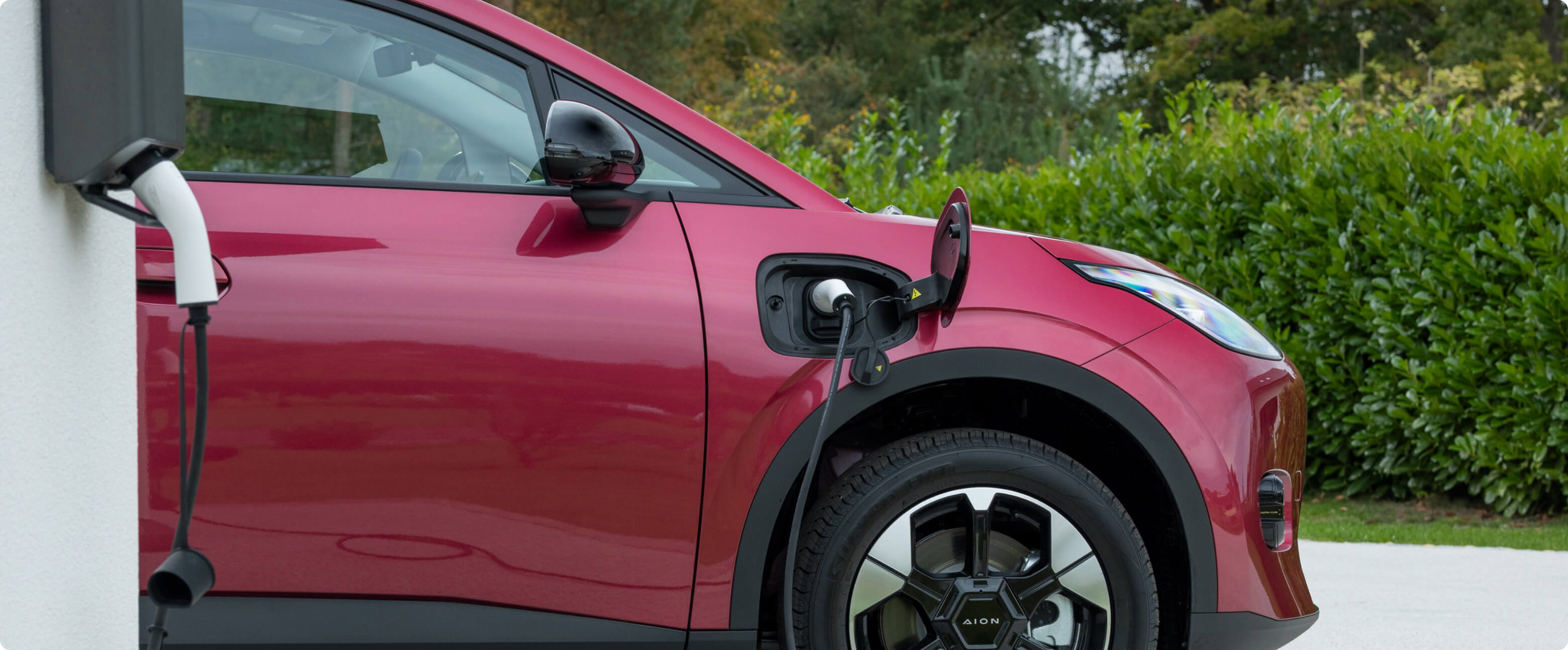 AION UT charging at home on a driveway