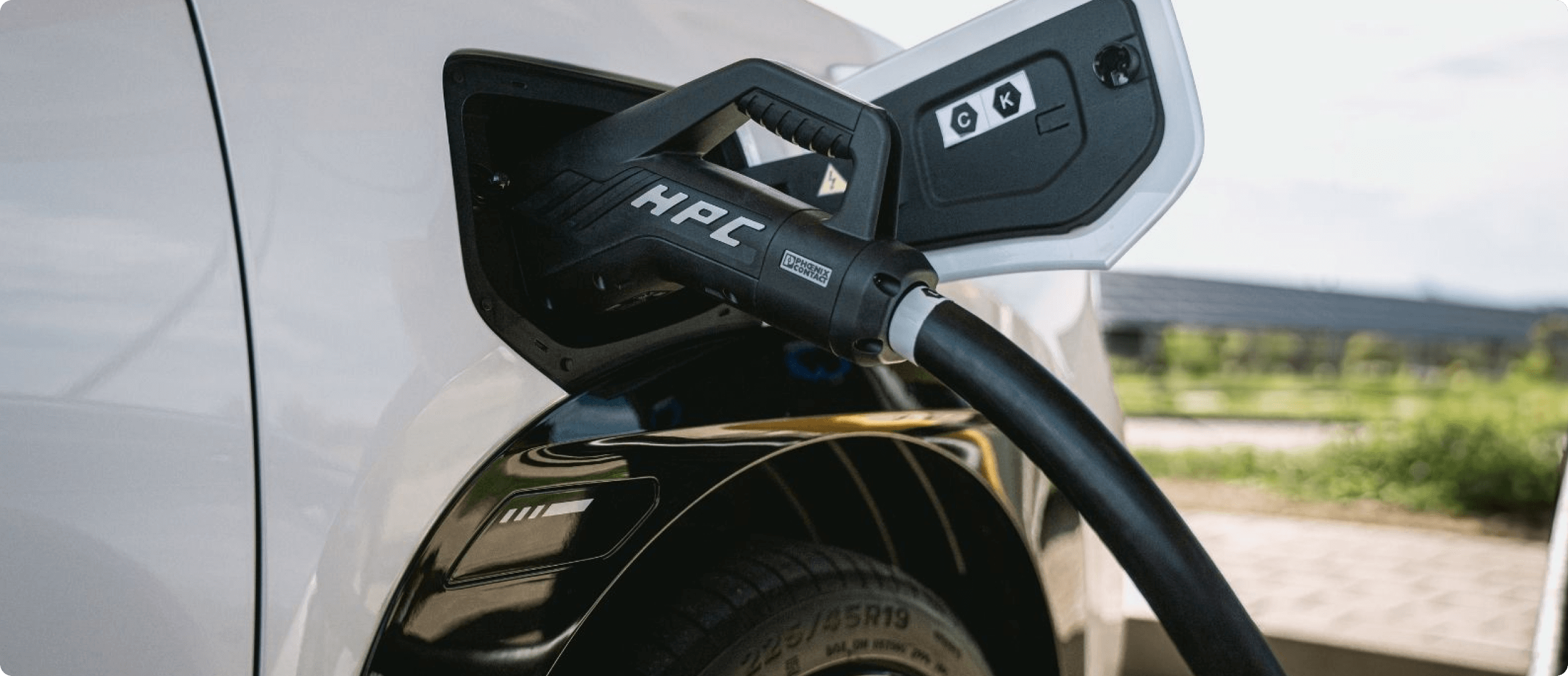 Close-up of an AION charging with an HPC fast charger plugged into the charging port