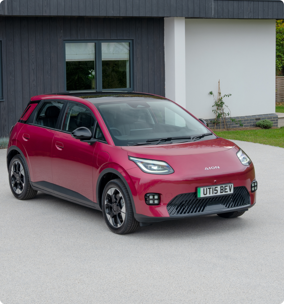 AION UT parked on a residential driveway, shown from the front three-quarter angle