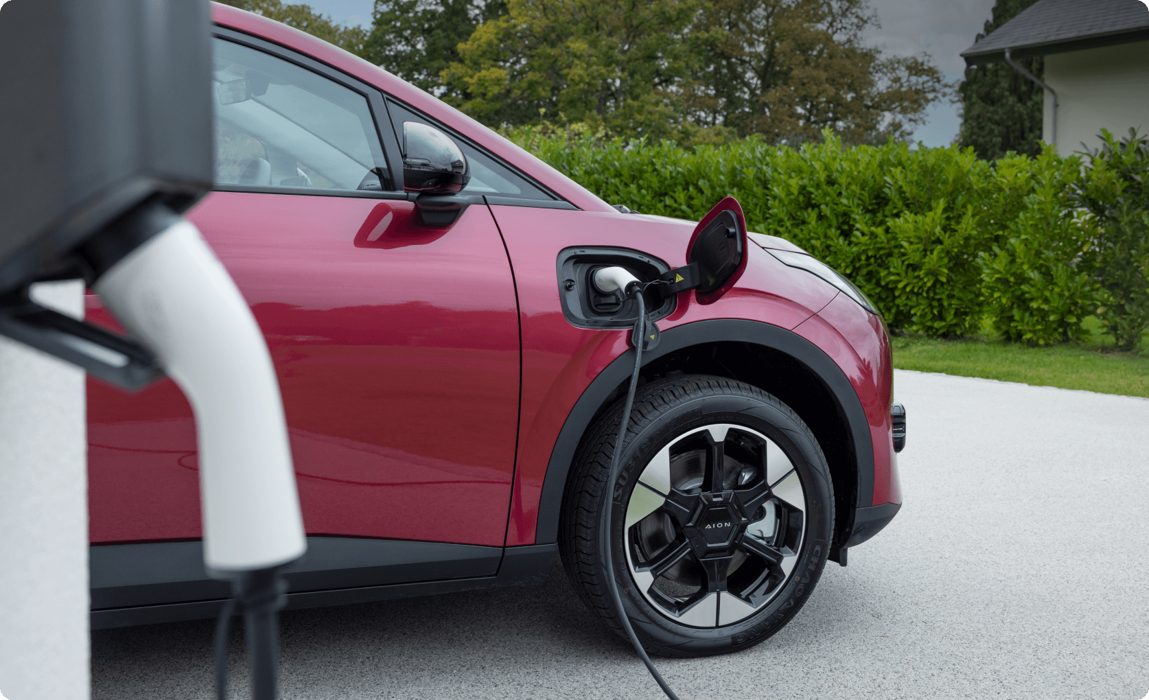 AION UT charging at home on a driveway