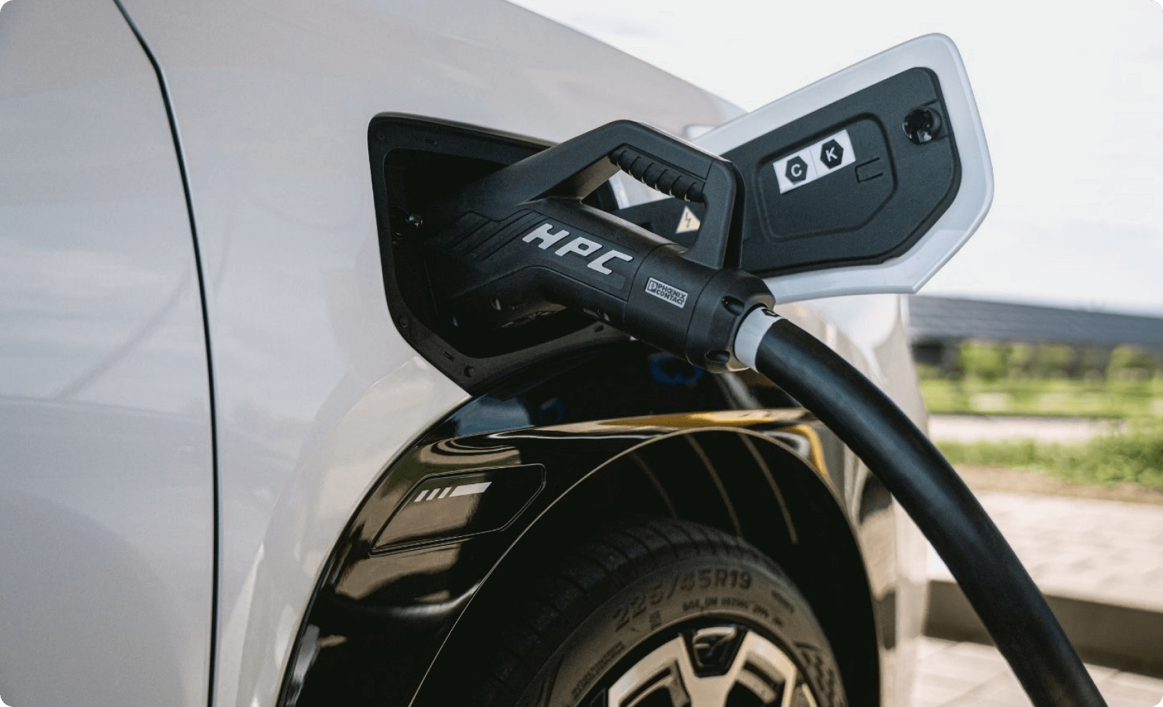 Close-up of an charging cable connected to an AION car