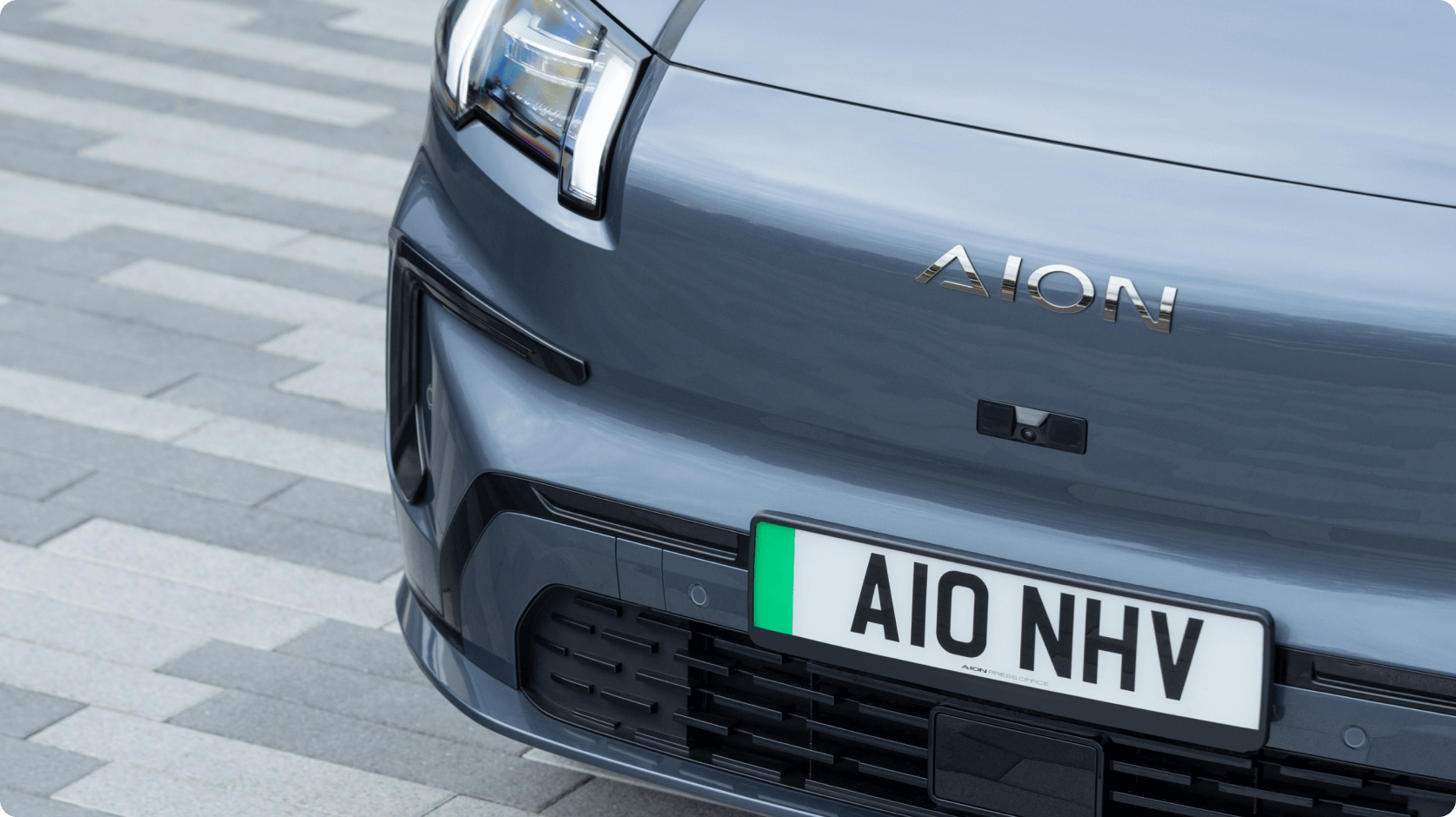 Close-up of the AION V front grille and badge