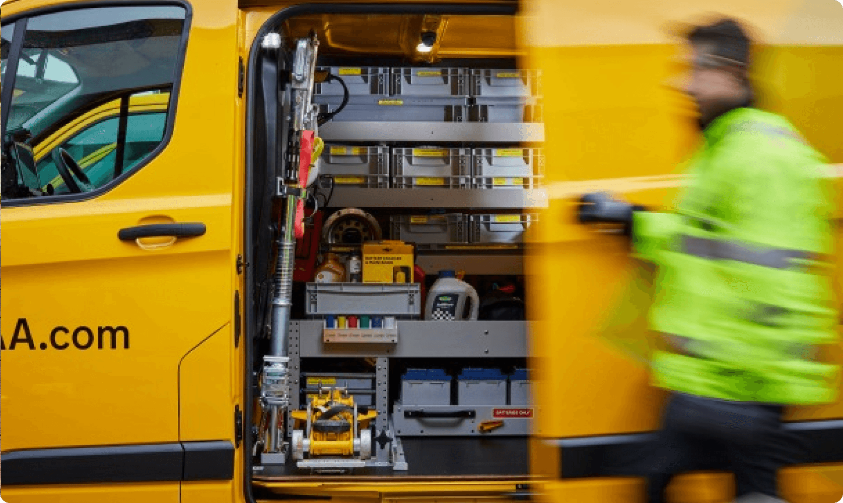 AA roadside assistance van with technician accessing equipment from the rear