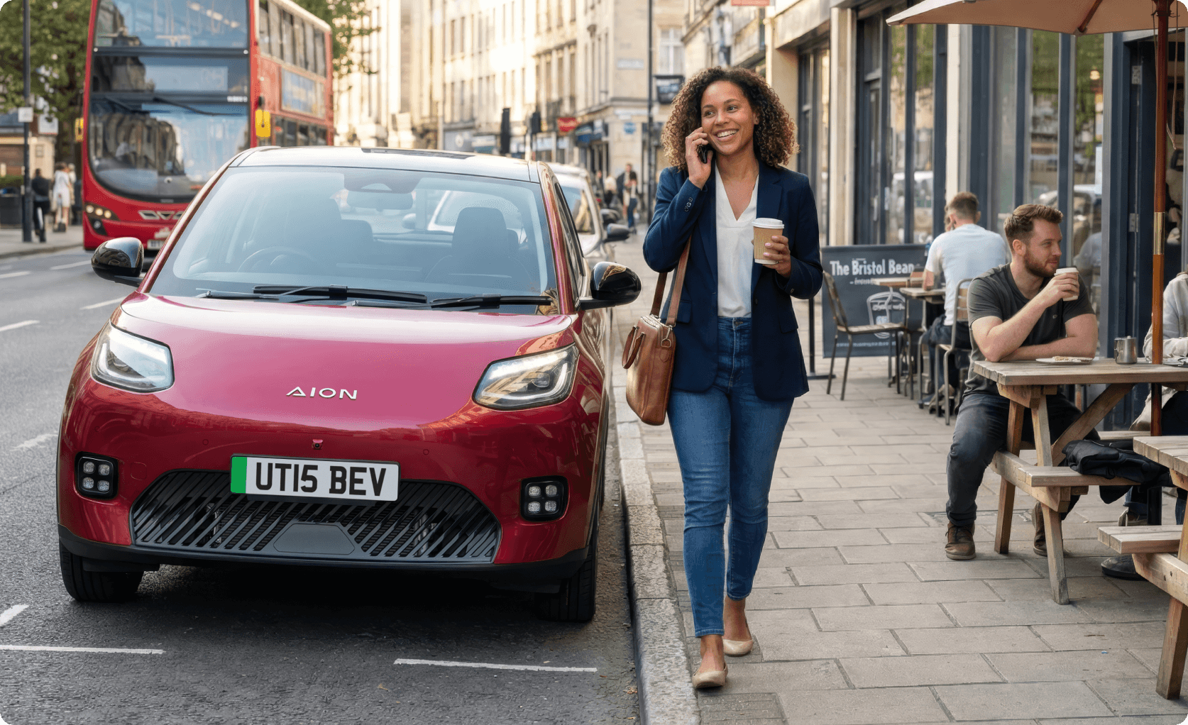 AION UT parked on a city street beside cafés