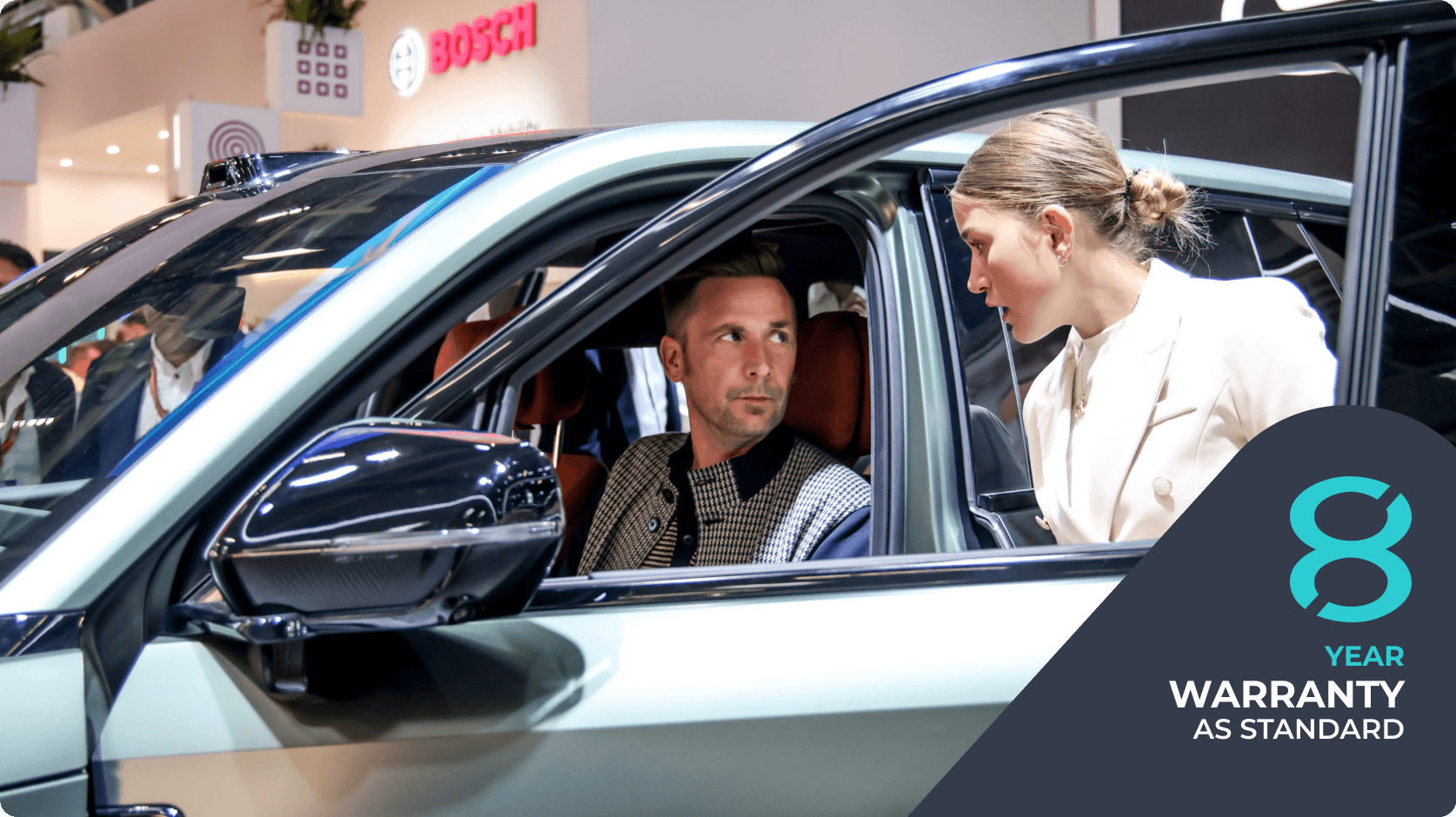 A customer speaking with a representative inside an AION car at a showroom