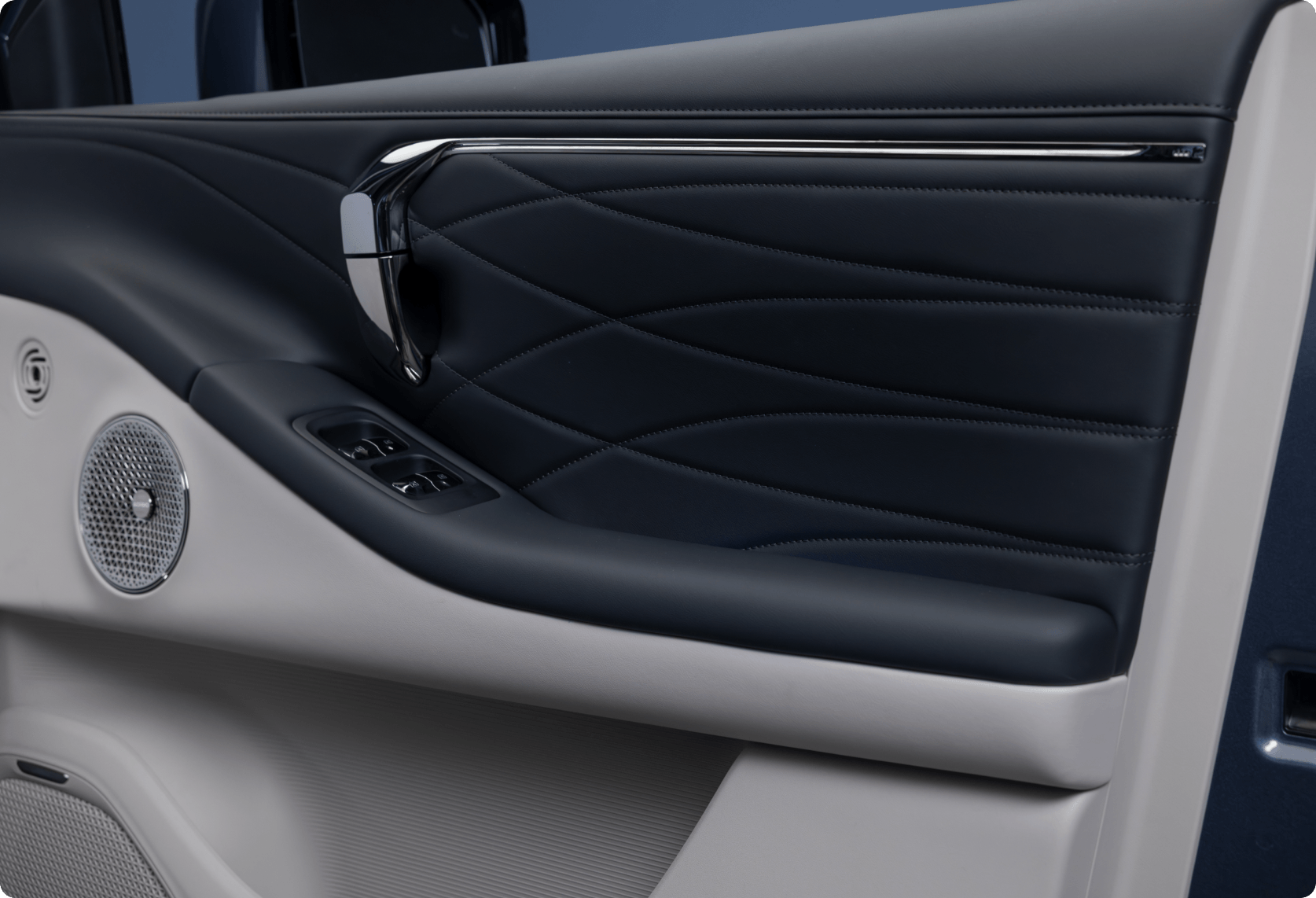 AION V interior door panel with quilted trim, metallic handle, and integrated speaker
