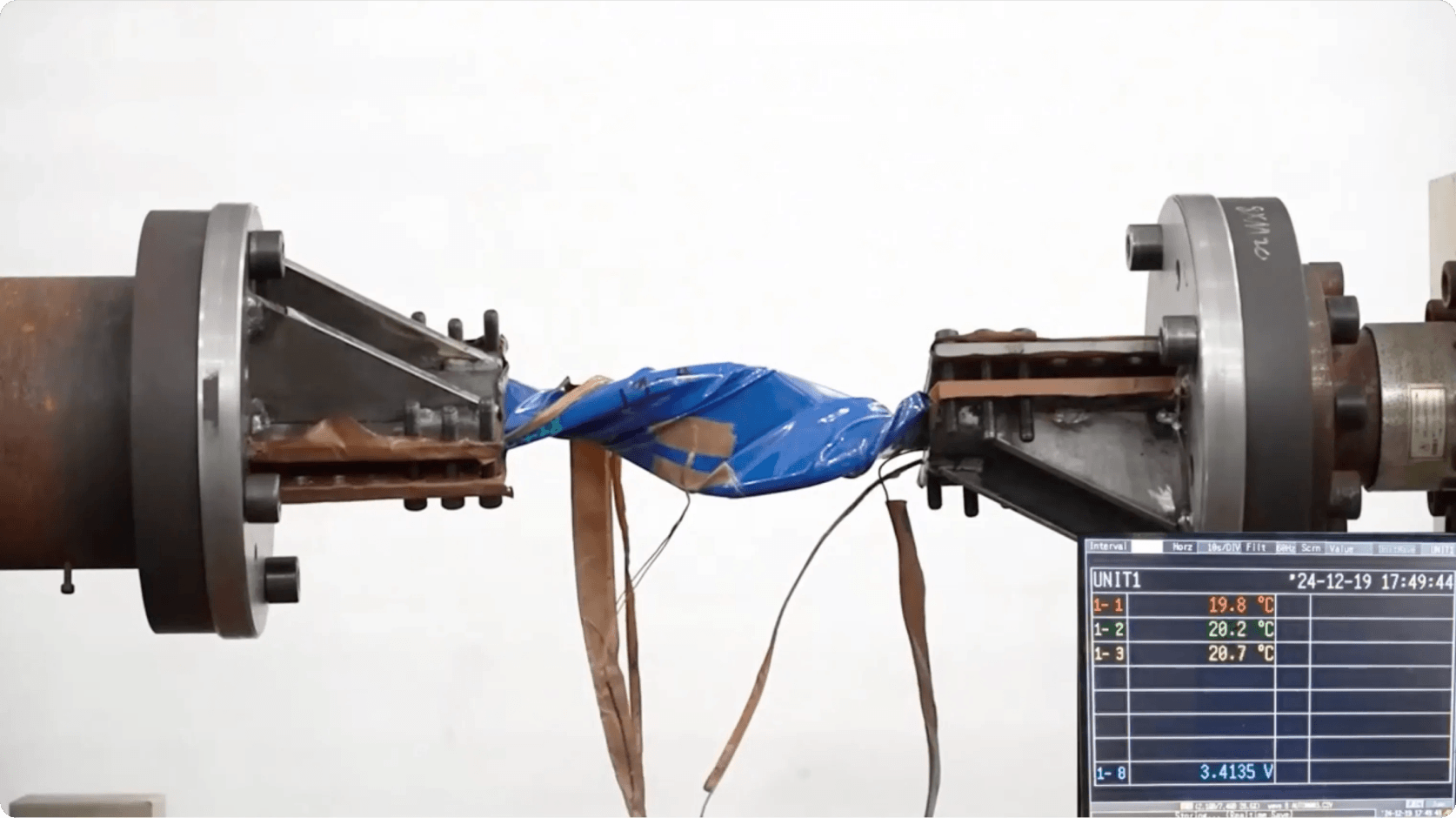 Battery component undergoing a durability and safety stress test in a laboratory setup