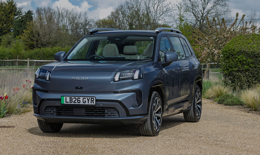 AION V parked on a gravel driveway in a landscaped countryside setting