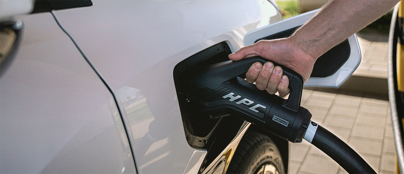 Close-up of an HPC rapid charging connector plugged into an AION V