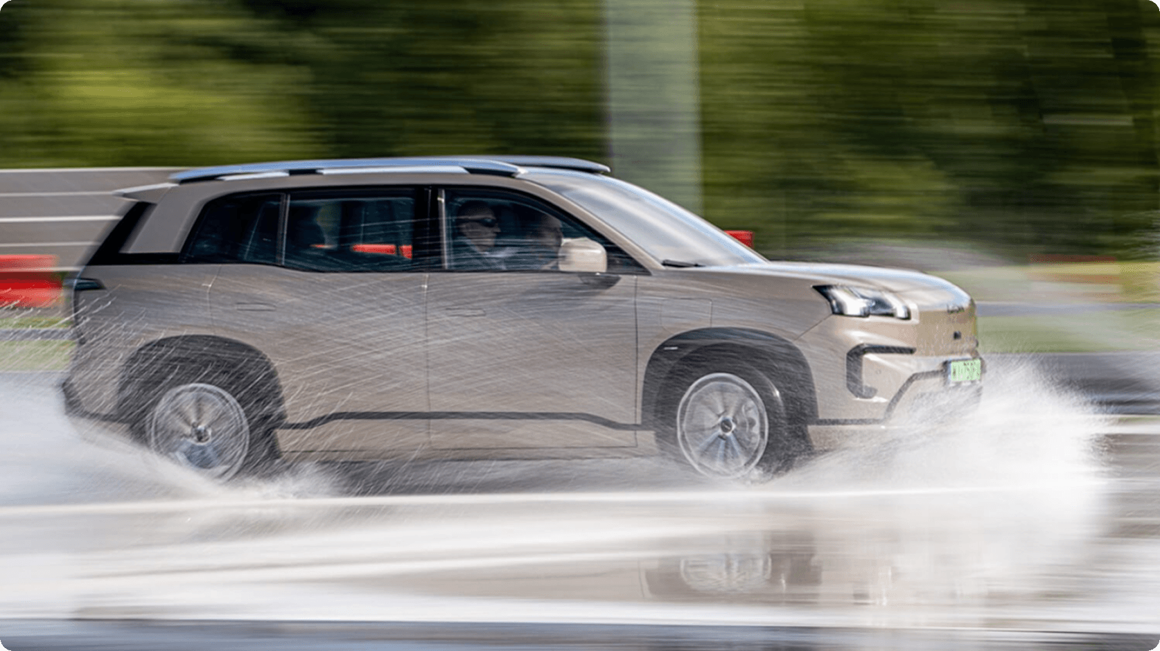 AION V driving through a wet handling course during vehicle stability testing