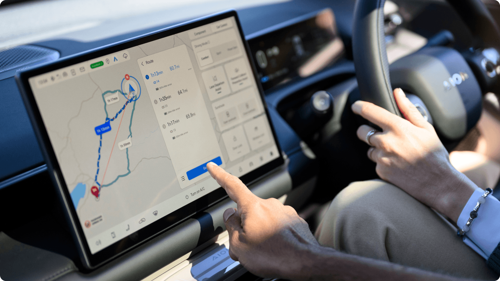 AION infotainment touchscreen displaying a navigation route and journey options