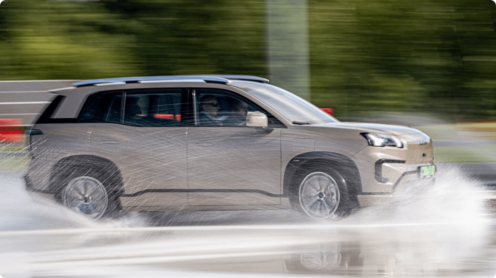 AION V driving through a wet handling course during vehicle stability testing