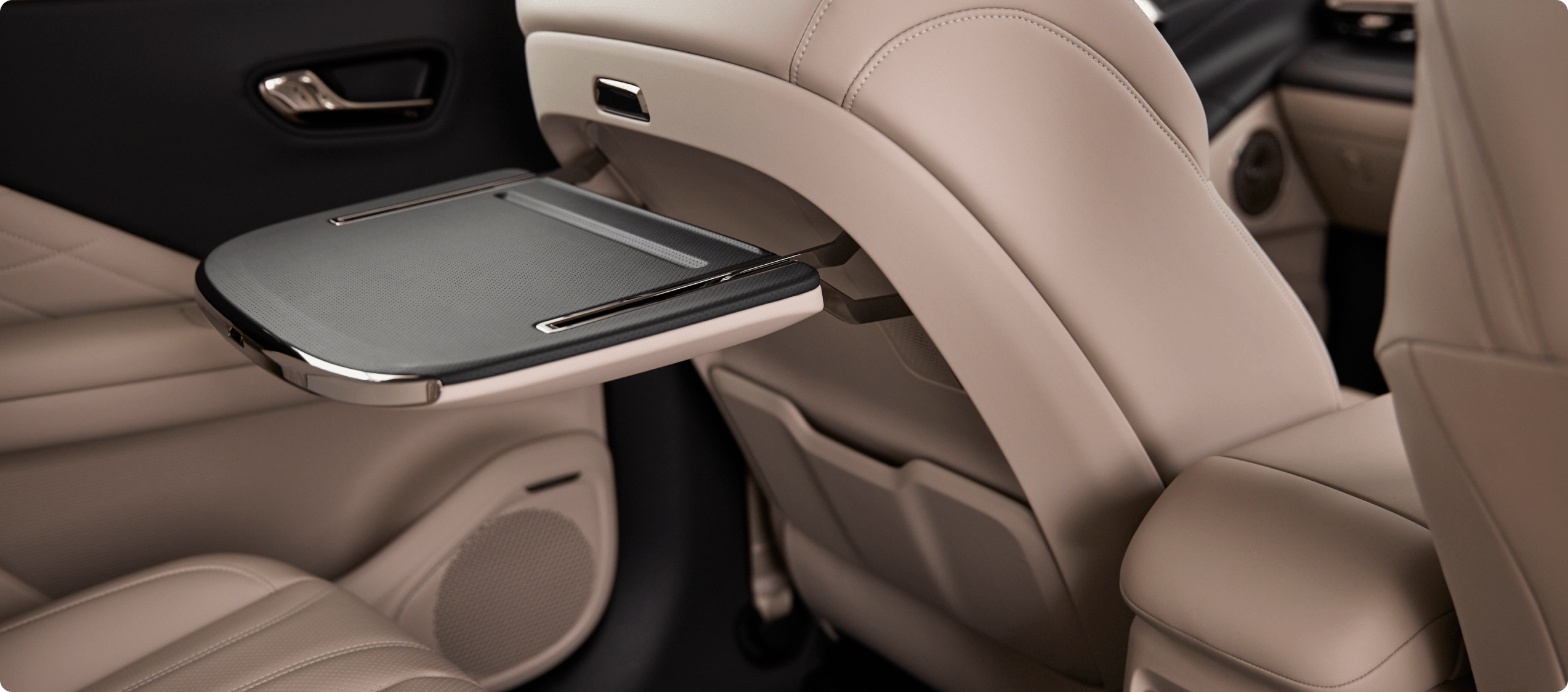 Fold-out table mounted to the back of an AION V front seat