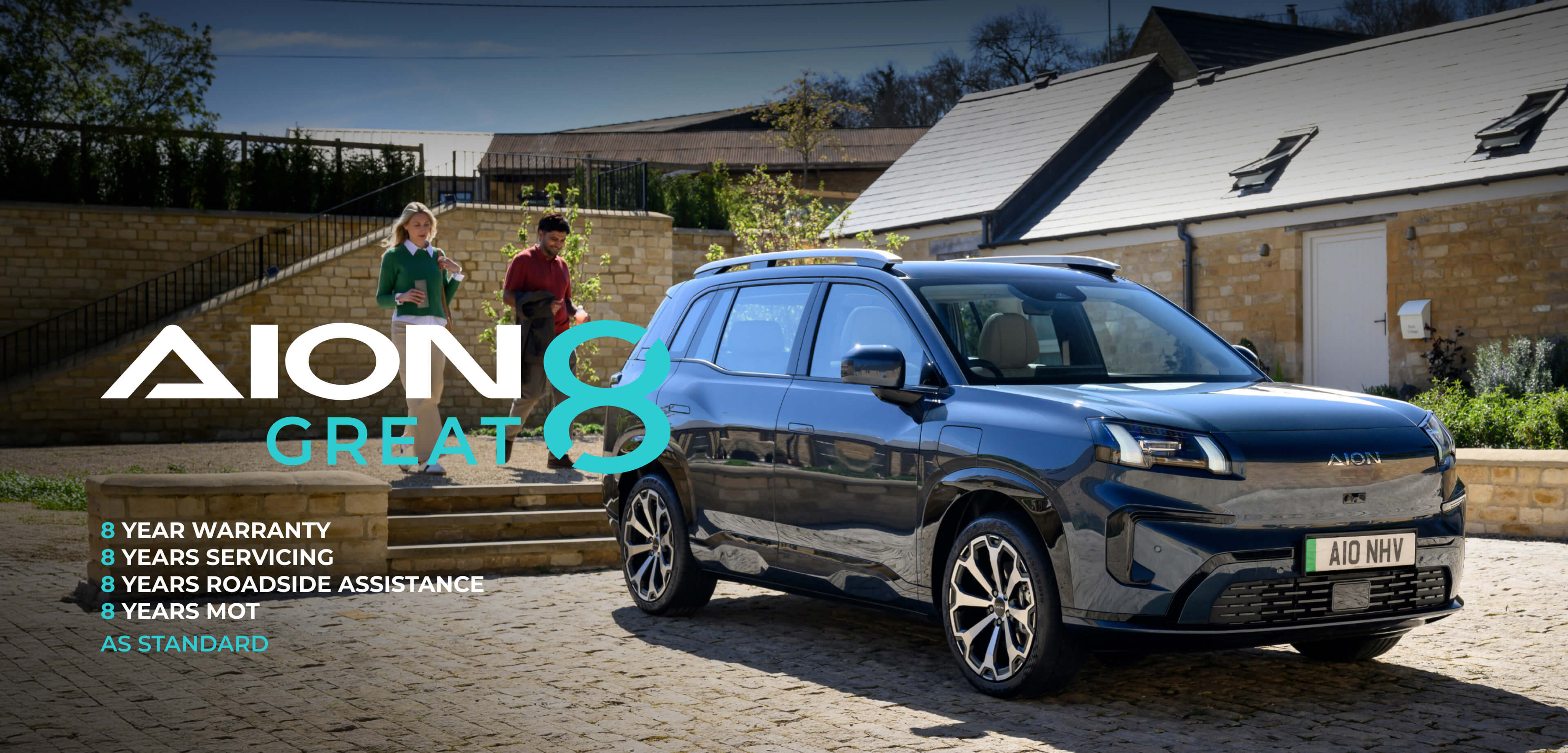 AION V parked outside a modern countryside home with on-screen text reading: "AION Great 8", "8-year warranty", "8-year servicing", "8-year roadside assistance", "8-year MOT" and "as standard"